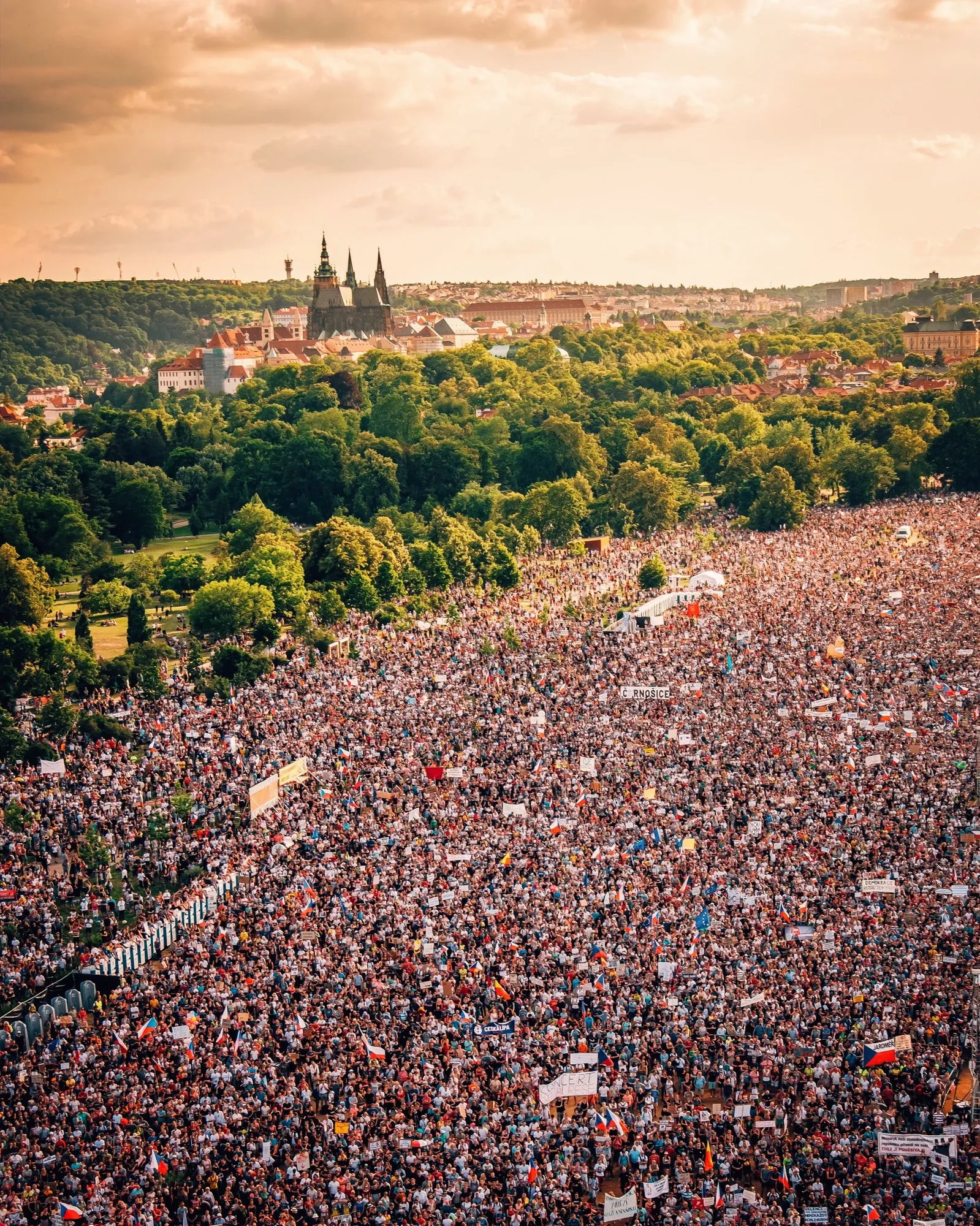  View from above of crowds protesting at Letna Park with Prague Castle as backdrop 