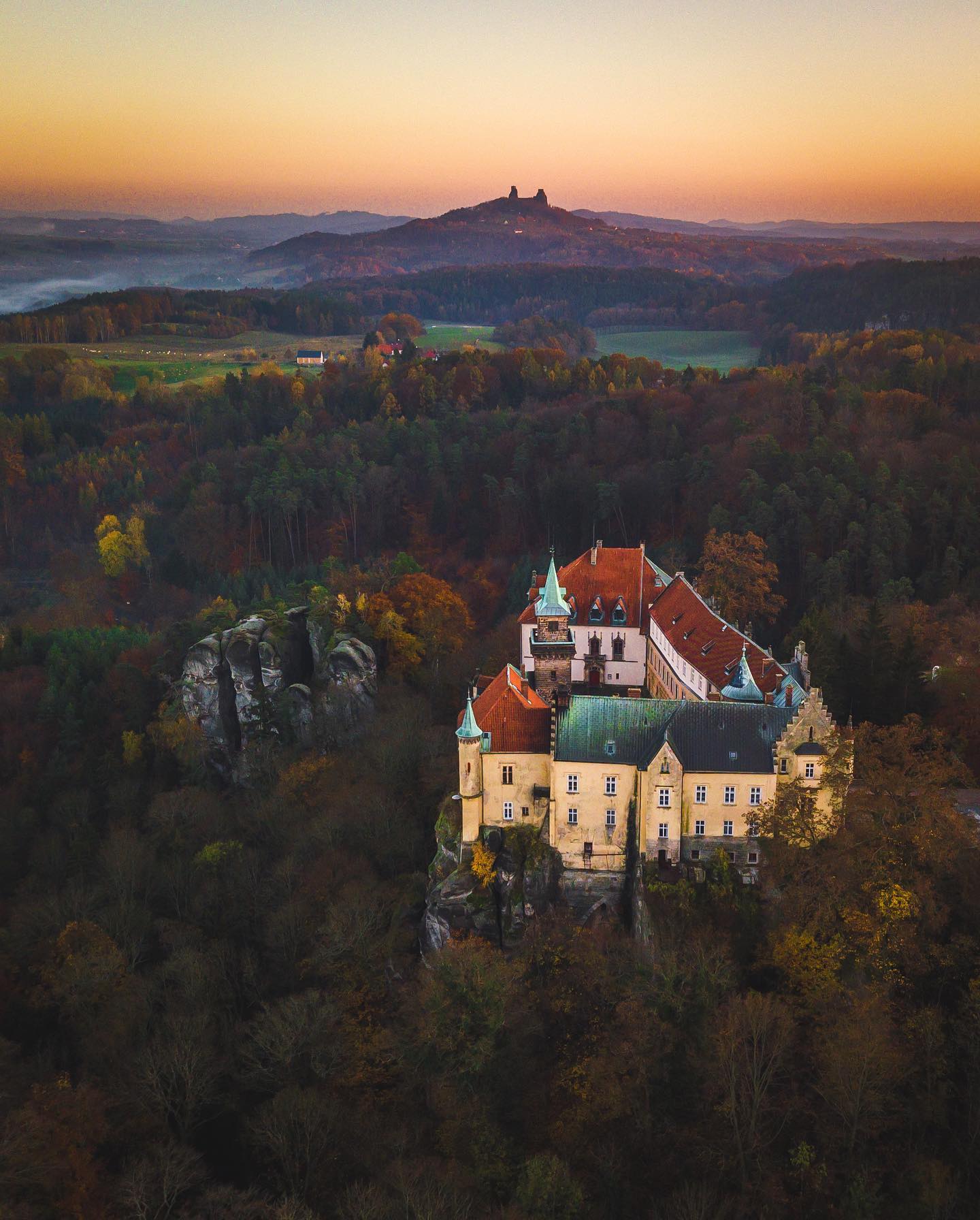 Hrubá Skála Castle and the Trosky castle in the background 🍁🍃🍂 #thisisczech #ceskyraj #travellocal #fromwhereidrone #fall #skalnimesto #hrubaskala #autumn #czroamers
